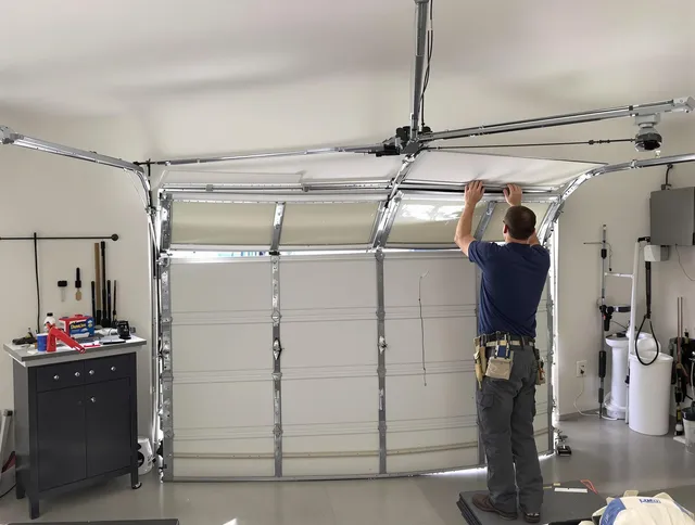 Plainville Garage Door Repair specialist performing precise section replacement on Plainville garage door
